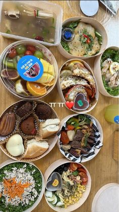 there are many different types of food in the bowls on the table, including salads and sandwiches