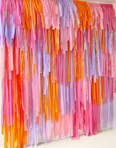 colorful streamers are hanging on the wall