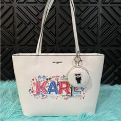 Karl Lagerfeld Paris Adele Large Tote Bag White Multi Grafitti Karl Pouch Grafitti Details Top Zipper Closure With Dual Straps Two Internal Slip Pockets And Credit Card Slots Exterior Pocket Karl Lagerfeld Face On Front With Logo Kl Removable White Karl Bag Charm Silver Tone Hardware Dimensions: Top Width: 16” Bottom Width: 15” Depth: 6” Height: 13.5” Handle Length: 11” Brand New Never Worn Same Day Shipping White Shoulder Bag With Logo And Double Handle, White Double Handle Shoulder Bag With Logo, White Rectangular Shoulder Bag With Logo, White Rectangular Logo Shoulder Bag, White Logo Rectangular Shoulder Bag, Designer White Shoulder Bag With Zipper Closure, White Rectangular Bag With Logo, White Bags With Logo For Daily Use, White Pouch Shoulder Bag With Detachable Handle