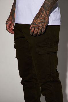 Available InBlack, Khaki, Olive, And Camouflage. Model Height: 6'2 - Waist: 32 - Wearing Large Big & Tall: Height 6'3 - Waist 42 - Wearing XXXL Button Closure Zip Fly Cargo Pants Elastic Hem Front And Back Pockets Cargo Pockets 31 Inseam 98% Cotton 2% Spandex Imported | Mens Kryptonite Cargo Pants in Olive Green size 30 by Fashion Nova Fitted Camouflage Cargo Pants With Straight Leg, Fitted Work Pants For Casual Streetwear, Fitted Combat Bottoms With Cargo Pockets, Military Style Fitted Bottoms For Streetwear, Casual Camouflage Pants With Hip Pockets, Fitted Khaki Cargo Pants With Tapered Leg, Fitted Military Style Bottoms For Streetwear, Urban Camouflage Straight Leg Cargo Pants, Fitted Khaki Tapered Leg Cargo Pants