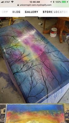 a painting is being made in the shape of a bed with trees painted on it