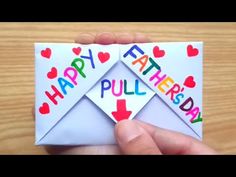 a hand holding an envelope with the words happy father's day written on it