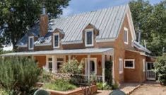 a large house with a metal roof and windows