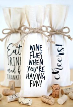 two wine bags with the words wine flies when you're having fun written on them