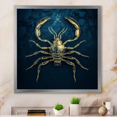 a blue and gold crab art print on a wall