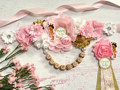 pink and white flowers are arranged in the shape of a heart with nameplates