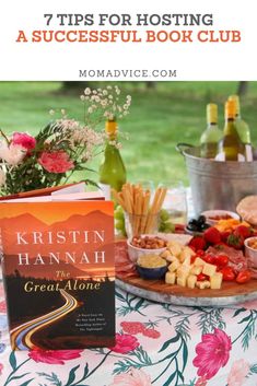 a table topped with food and drinks next to a book