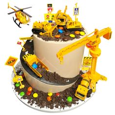 there is a cake with construction vehicles on it