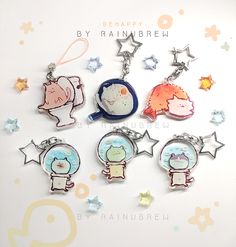 six keychains with cartoon characters on them sitting in front of star shaped stars