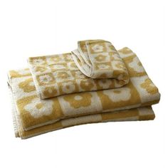 three towels stacked on top of each other in yellow and white colors, with the letter g printed on them