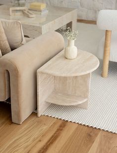 a living room scene with focus on the couch and coffee table, along with two chairs