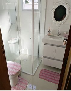 a bathroom with a sink, toilet and shower stall in it's own area