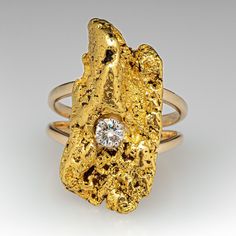 This unique ring features one round brilliant cut diamond and a natural gold nugget. This ring is currently a size 6.5. 14k Gold Nugget Diamond Ring, Elegant 14k Gold Nugget Diamond Ring, Unique Gold Jewelry With Single Diamond, Yellow Gold Nugget Diamond Ring As Gift, Elegant Nugget Diamond Ring For Anniversary, Elegant Yellow Gold Nugget Rings, Fine Jewelry Yellow Gold Nugget Rings, Unique Gold Round Cut Diamond Ring, Unique Gold Diamond Ring With Round Cut