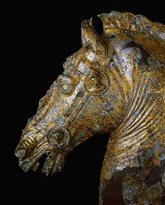 a close up of a horse statue on a black background