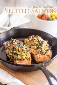 shrimp and spinach stuffed salmon in a skillet