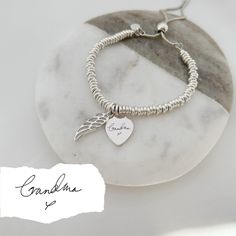 Our sterling silver memorial bracelet is at the heart of our special jewellery collection designed to commemorate cherished memories. Our beautiful range of engraved silver jewellery makes a touching memorial keepsake, presented on your choice of six elegant quote cards: With Love Thinking Of You Your Wings Were Ready But My Heart Was Not Forever In My Heart Fly With The Angels, Dance With The Stars Or a fresh white, plain quote card. This elegant sterling silver bracelet combines a silver heart Sterling Silver Name Bracelet With Heart Charm For Anniversary, Sterling Silver Keepsake Bracelet, Sterling Silver Keepsake Bracelets In Silver, Anniversary Sterling Silver Name Bracelet With Heart Charm, Silver Engraved Bracelet For Memorial, Silver Engraved Bracelet For Memorials, Engraved Silver Bracelet For Memorial, Memorial Engraved Silver Bracelets, Silver Bracelets Keepsake For Mother's Day