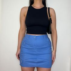 "Reworked skirt made from PreLoved cargo trousers, dusty blue colour with front and back pockets with button closure.  Colour: Light Blue Style: Cargo Skirt Size: Best fits UK 12 (US 8)* Measurements: Waistband - 15\" Length - 15\"   Model: Size Top UK 8/10 (US 4/6) Bottoms UK 10/12 (US 6/8) Height 5ft5\"   *Please contact us if you would like this item to be altered to fit a smaller size." Y2k Blue Bottoms With Cargo Pockets, Blue Y2k Bottoms With Cargo Pockets, Y2k Blue Skirt With Pockets, Fitted Utility Skirt, Blue High Waist Cotton Cargo Skirt, Blue Cotton Y2k Style Skort, Blue Cotton Y2k Skort, Y2k Style Blue Cotton Skort, Casual Cargo Pocket Skirt