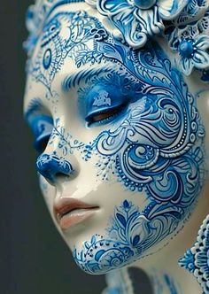 a woman with blue and white face paint