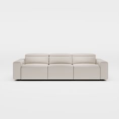 a white leather couch sitting on top of a white floor