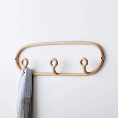 a coat rack with three hooks and an umbrella