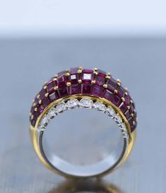 For Sale on 1stdibs - 18 kt. yellow & white gold, 75 square-cut rubies ap. 7.00 cts., 22 round & single-cut diamonds ap. .95 ct., ap. 9.4 dwts. Size 6. Rubies: medium deep raspberry, Luxury Asscher Cut Ruby Ring, Luxury Red Ruby Ring Baguette Cut, Luxury Red Baguette Cut Ruby Ring, Luxury Red Diamond Ring With Single Cut Diamonds, Luxury Ruby Ring With Diamond Baguette Cut, Luxury Diamond Ruby Ring, Luxury Diamond Ruby Ring With Baguette Cut, Luxury Ruby Ring With Diamonds, Luxury Ruby And Diamond Ring In Yellow Gold