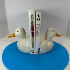 a bookend made out of a duck and two books on top of each other