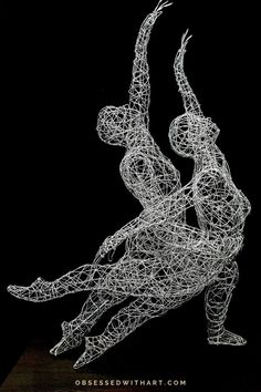 a wire sculpture is shown in black and white, with the image of two people holding hands