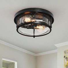 a ceiling light in a room with white walls