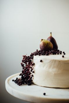 a cake with white frosting and fruit on top