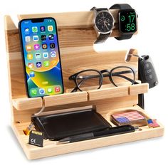 an apple watch, cell phone and wallet in a wooden holder