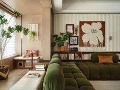 a living room filled with lots of green furniture