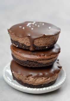 three chocolate donuts stacked on top of each other