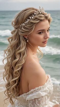 a woman with long blonde hair wearing a tiara and pearls on her head standing in front of the ocean