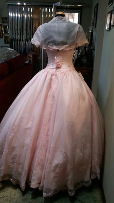 a pink dress on display in a room