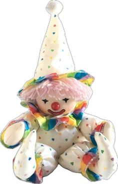 a stuffed animal with a clown hat and polka dots on it's face is sitting down