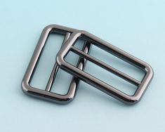 two metal buckles on a blue background with space for the word's logo