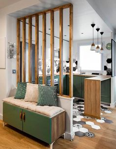 a living room filled with furniture next to a kitchen and an open floor plan on top of a hard wood floor