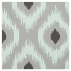 a gray and white rug with an abstract design