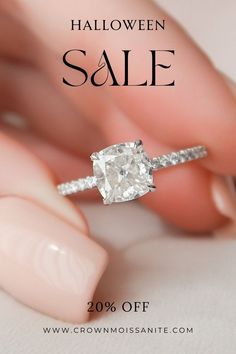 a woman's hand holding an engagement ring with the words halloween sale on it