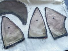 three pieces of cloth with holes in them on a piece of fabric that has been stitched together