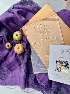 a purple and gold wedding suite with matching brochure, card and pumpkins