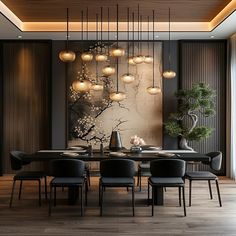 a dining room table with black chairs and lights hanging from the ceiling