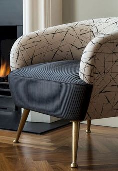 a chair sitting on top of a hard wood floor in front of a fire place