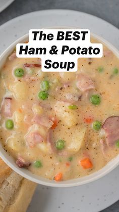 a bowl of ham and potato soup on a white plate with a piece of bread