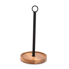 a round wooden stand with a black ring on it's end and a circular metal object in the middle