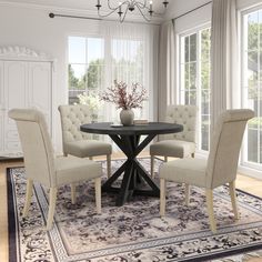 a dining room table with four chairs around it