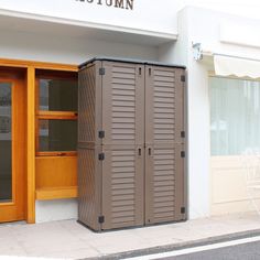 a tall brown storage cabinet sitting outside of a store