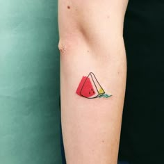 a watermelon slice tattoo on the arm