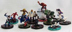 a bunch of action figures are on the white tablecloth with one person standing in front of them