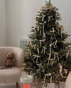 a small christmas tree is decorated with ribbons